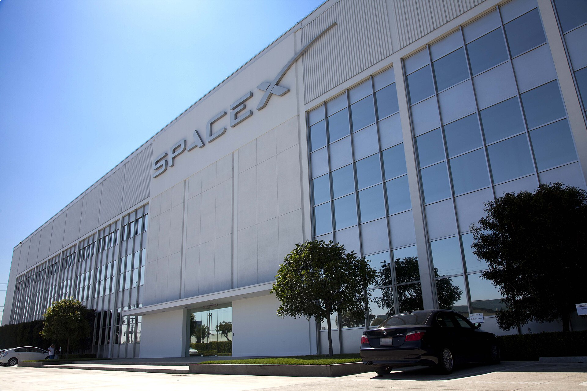 The SpaceX headquarters building in Hawthorne, California, with the SpaceX logo on its white facade