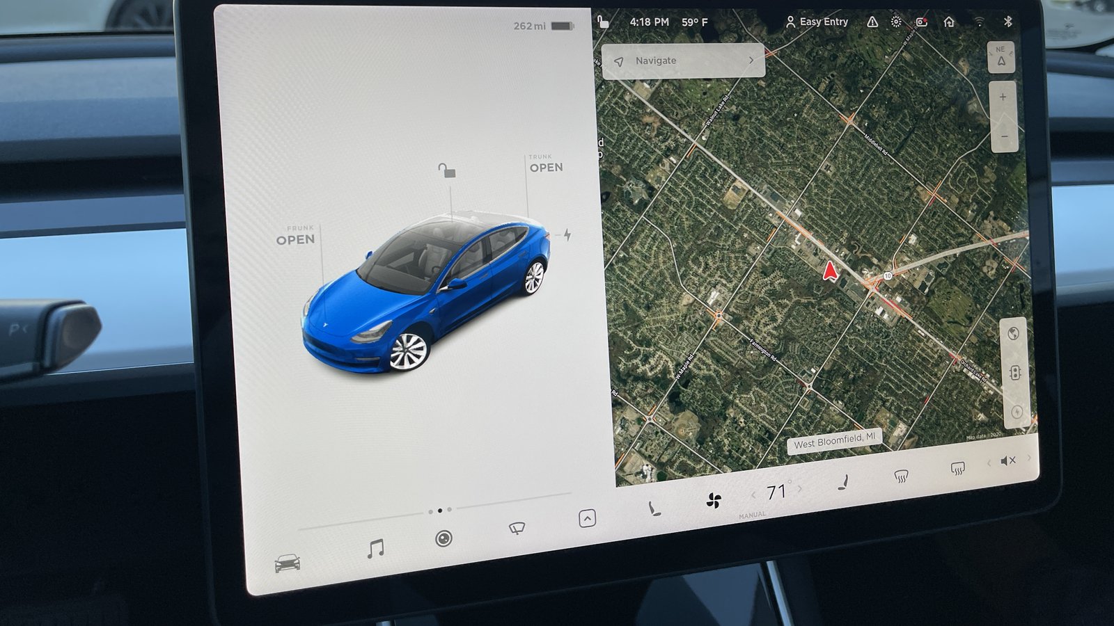 A Tesla Model 3 touchscreen showing the car on the left and a satellite navigation map on the right