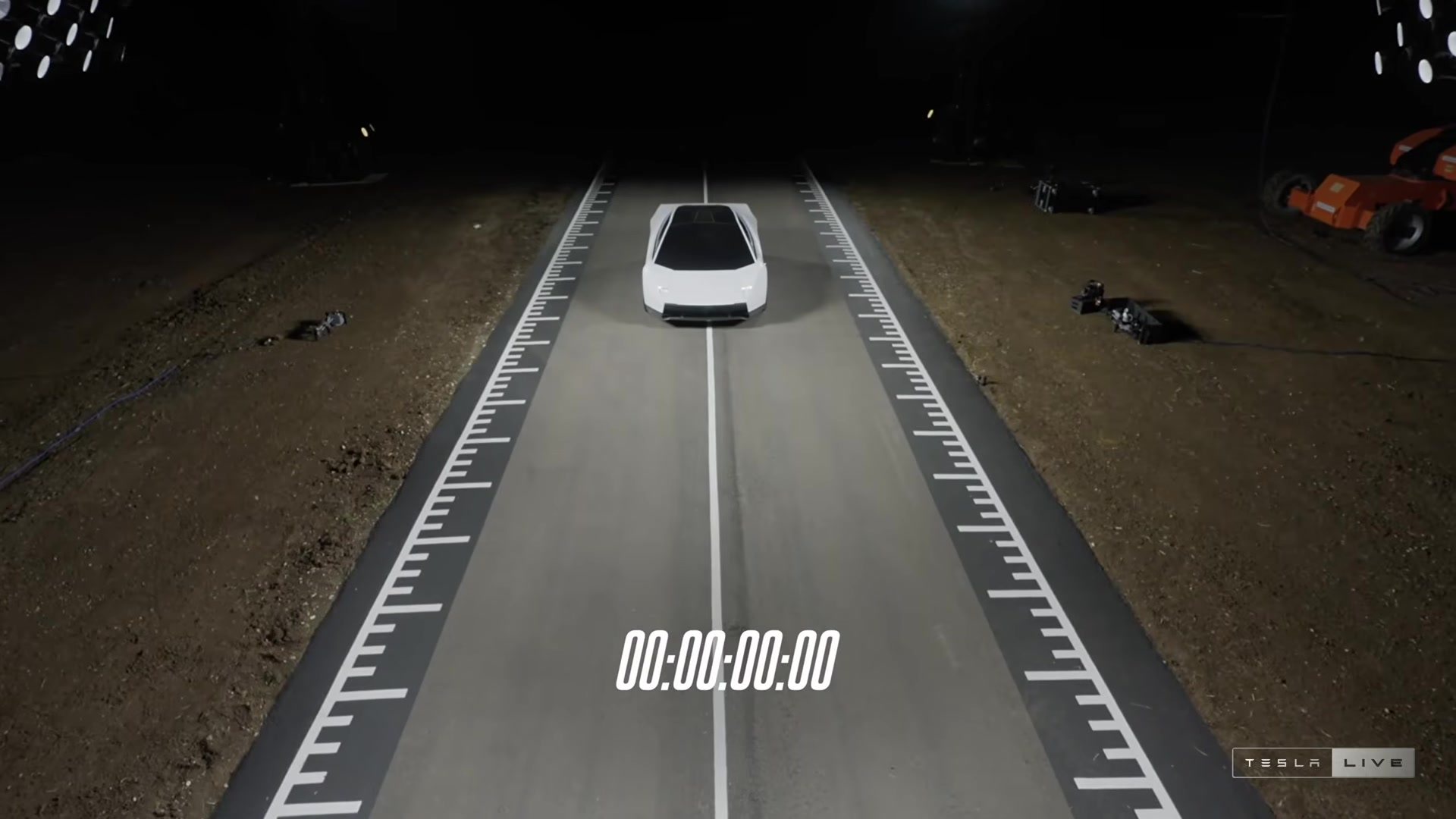 The Roadster lined up on a lit timing strip at night, shown in the stream