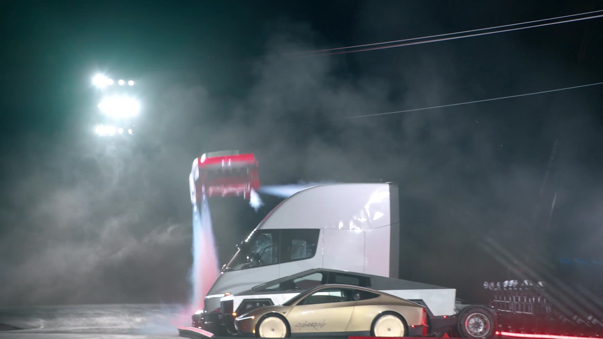 The Roadster landing beside a Tesla Semi in a cloud of thruster gas