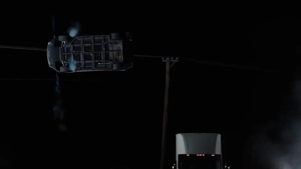 Overhead view of the Roadster rotating in the air above the parked Teslas