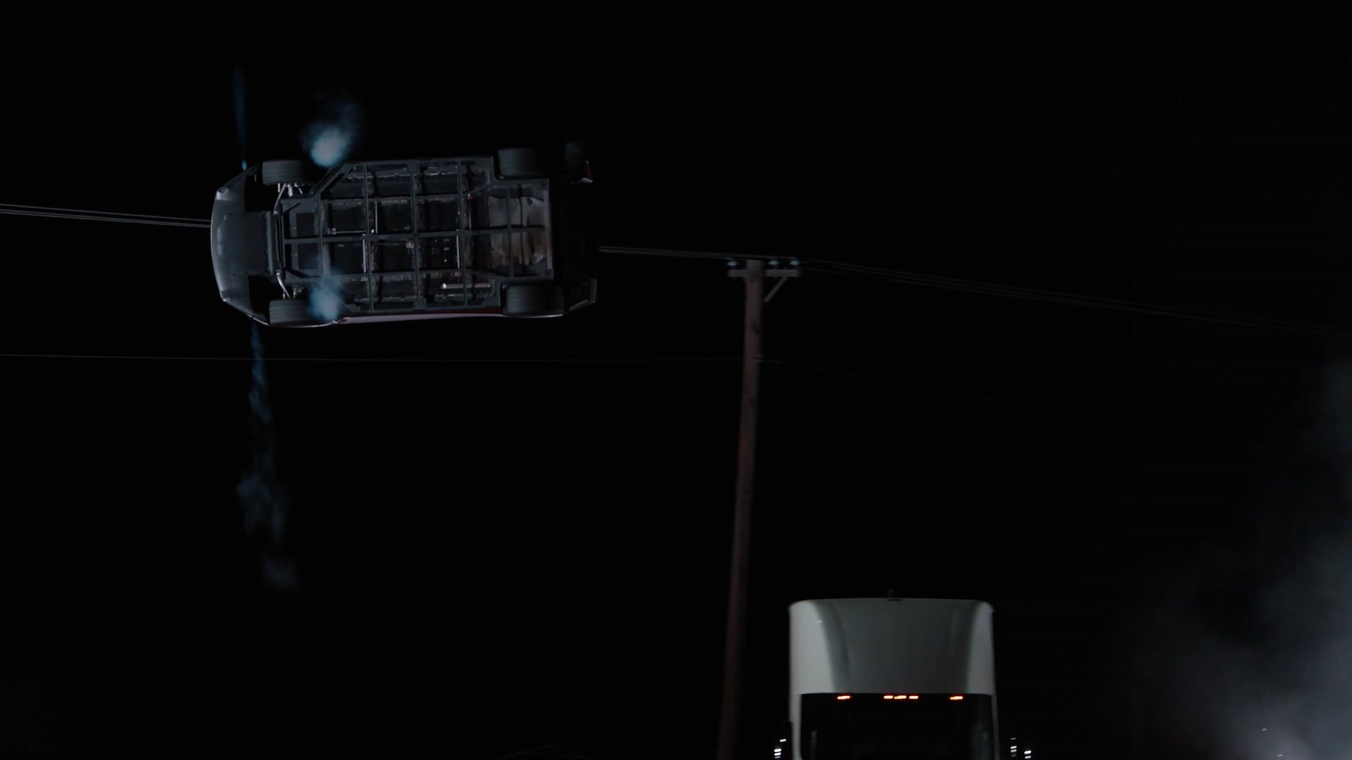 Overhead view of the Roadster rotating in the air above the parked Teslas