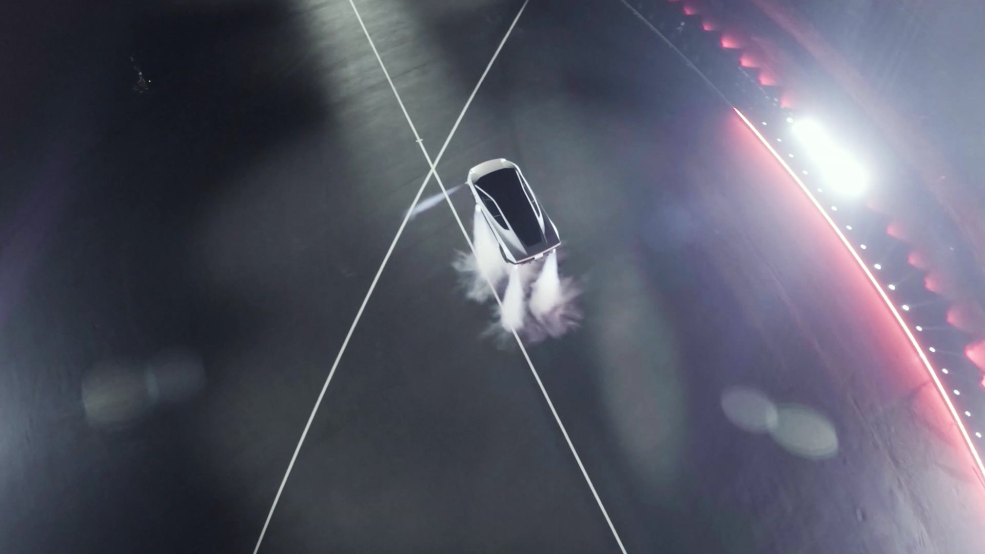 The Roadster flipping in mid-air after leaving the ramp, in a cloud of thruster gas