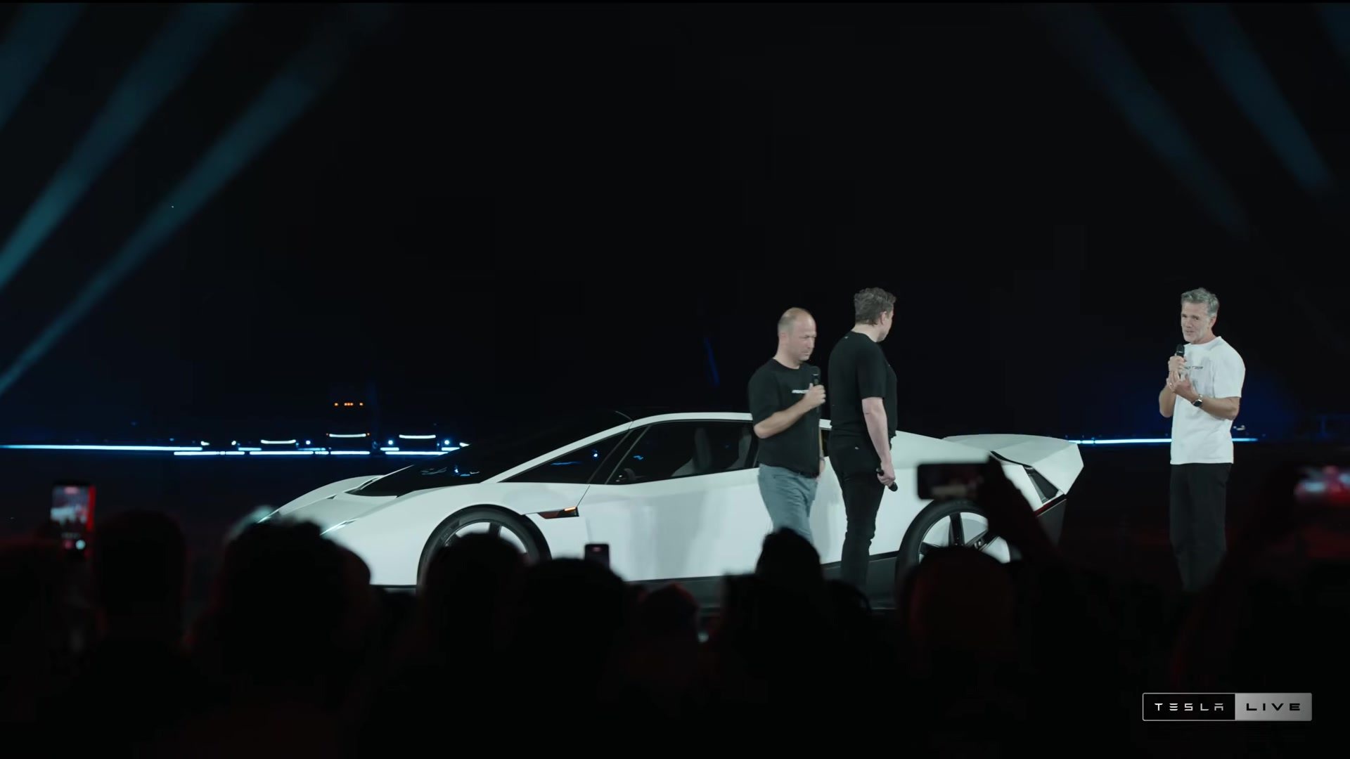 The Roadster on stage with Tesla presenters beside it